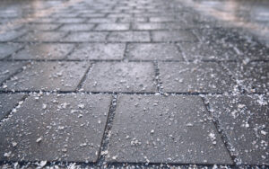 salt on sidewalk and roadway to keep snow from piling up and becoming ice to injury people