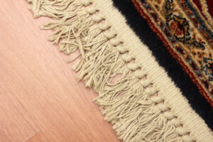 edge of persian rug fringe on around the perimeter of area rug in home to add decor and design